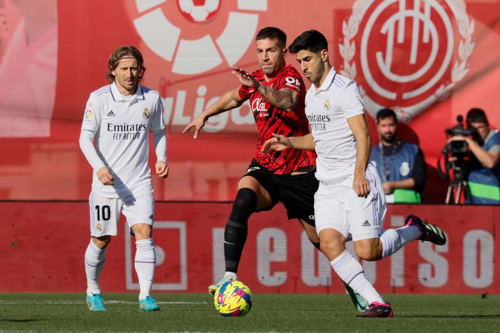 PALMA DE MALLORCA, 05/02/2023.- El defensa del Real Mallorca Nastsic (c) disputa el balón ante el delantero del Real Madrid Marco Asensio (i) durante el Partido de La Liga que juegan el Mallorca y el Real Madrid en el estadio de Son Moix.- EFE/CATI CLADERA