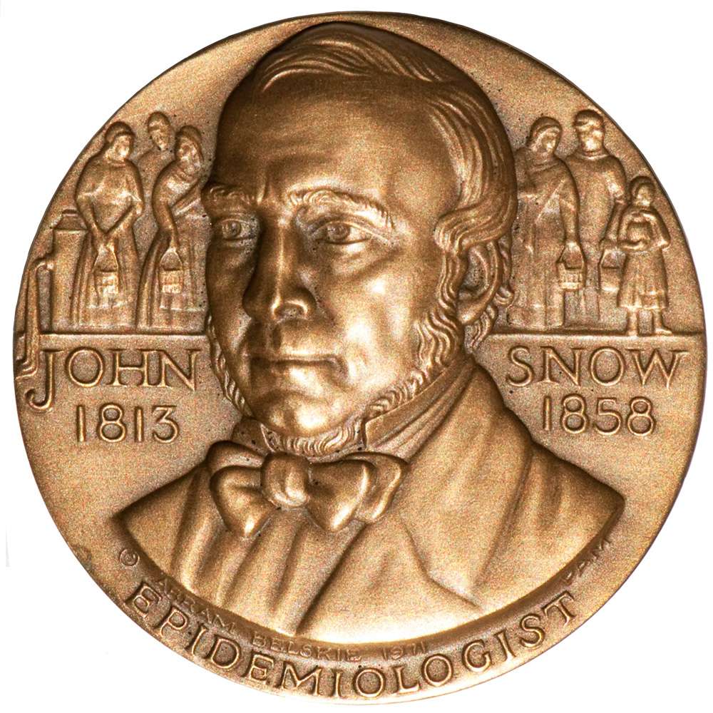 Medalla en honor al doctor John Snow. Bronce (44 mm, 61 g) La medalla en el anverso, documenta los años de su nacimiento (1813) y muerte (1858). Muestra las personas que reciben agua contaminada con cólera de una bomba del vecindario (arriba a la izquierda) en Londres, Inglaterra. El reverso de la medalla se centra en 1849, el segundo de dos años (1848-49) cuando el cólera regresó a Londres, luego de la epidemia anterior de 1831-1832. Las personas en el Londres industrial (simbolizado por el humo que sale de una fábrica) se enfermaron al consumir agua contaminada, como lo ilustra el agua que fluye desde la bomba a la derecha. Se está arrojando una campana en la parte superior de la medalla, luego de una muerte por cólera. En el lado derecho, una madre sostiene a su bebé, preocupado de que el cólera lo afecte, mientras observa a un hombre sostener a una persona enferma o muerta.