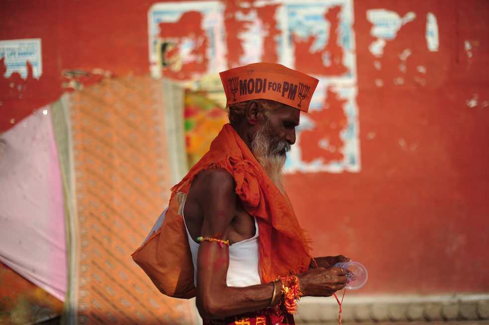 Un Sadhu, hombre sagrado, usa un gorro de la campaña de Narendra Modi. / AFP