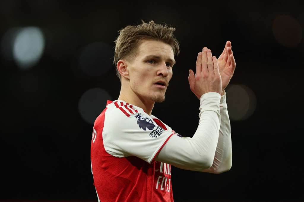 Arsenal's Norwegian midfielder #08 Martin Odegaard applauds at the end of the English Premier League football match between Arsenal and Brighton and Hove Albion at the Emirates Stadium in London on December 27, 2025.