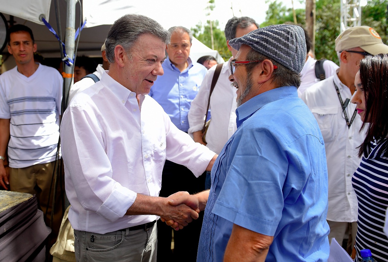 El presidente Juan Manuel Santos saluda a Timochenko, máximo jefe de las Farc, luego del acto de dejación de armas en Mesetas (Meta). / Presidencia