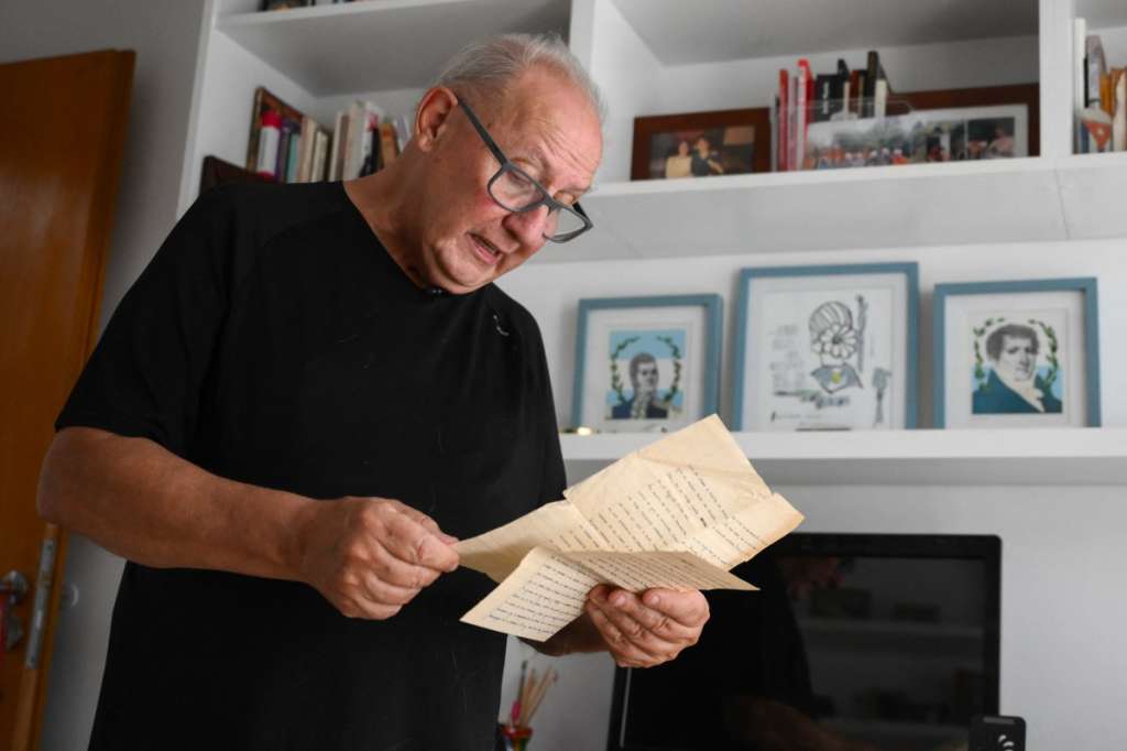 Pablo Diaz, 67, who was kidnapped in La Plata on September 16, 1976 during the military dictatorship (1976-1983), reads one of the letters he wrote to his family while in captivity during an interview with AFP in La Plata, Buenos Aires province, Argentina, on March 13, 2026.