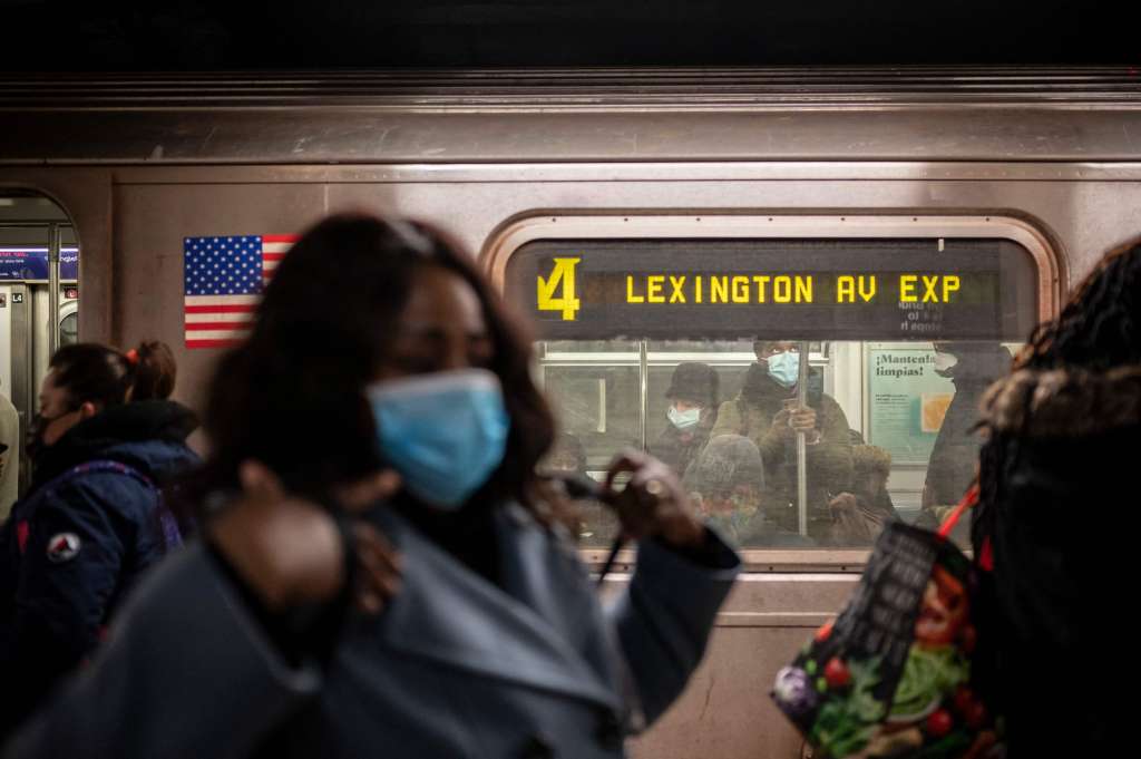 (FILES) In this file photo taken on March 16, 2021 passengers wearing facemasks ride a subway in New York. New Yorkers will receive free train rides if they get vaccinated against Covid-19 in subway stations, Governor Andrew Cuomo announced May 10, 2021 as part of a move to speed up immunizations. / AFP / Ed JONES