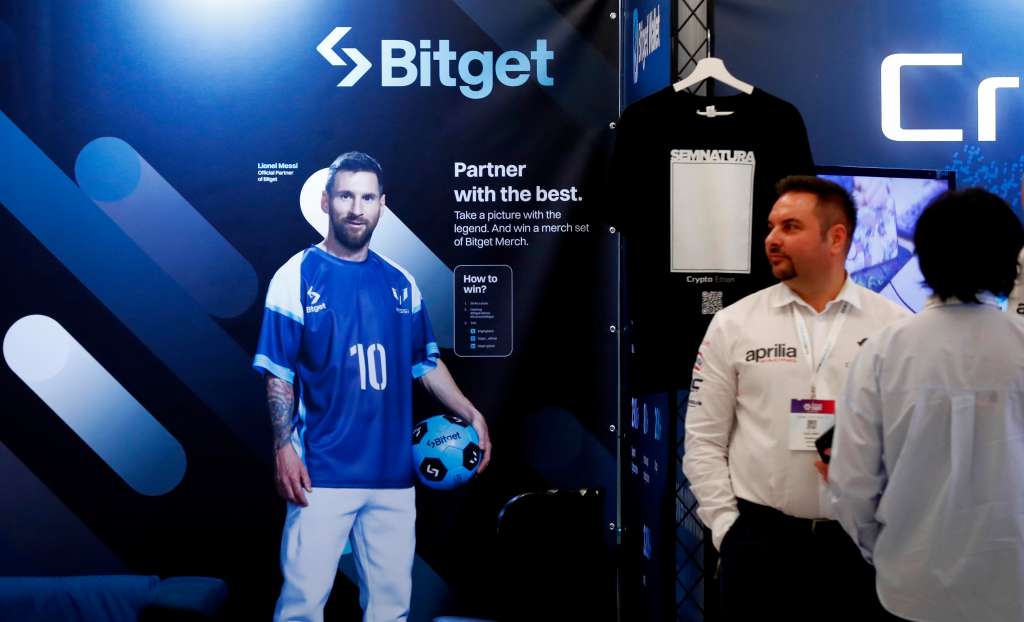 Bucharest (Romania), 04/03/2024.- Participanta, backed by an advertise poster showing Argentinian soccer star Lionel Messy at the Crypto Expo Europe 2024 conference in Bucharest, Romania, 04 March 2024. Bitget entered into a partnership with soccer star Lionel Messi in October 2022, becoming the only crypto exchange partner of the legendary Argentinean football player, and Messi was named Bitget brand ambassador. Crypto Expo Europe conference, held on 03 and 04 March in Bucharest, is one of the largest events in the crypto and blockchain industry, aiming on the crypto markets in Central and Eastern Europe and bringing together builders and top Web3 educators to boost a blockchain and fintech startup boom. The conference gathers more than 3,000 attendees, 115 speakers, 59 international exhibitors and organizing 81 workshops and seminars for the 2024 edition. (Rumanía, Bucarest) EFE/EPA/Robert Ghement