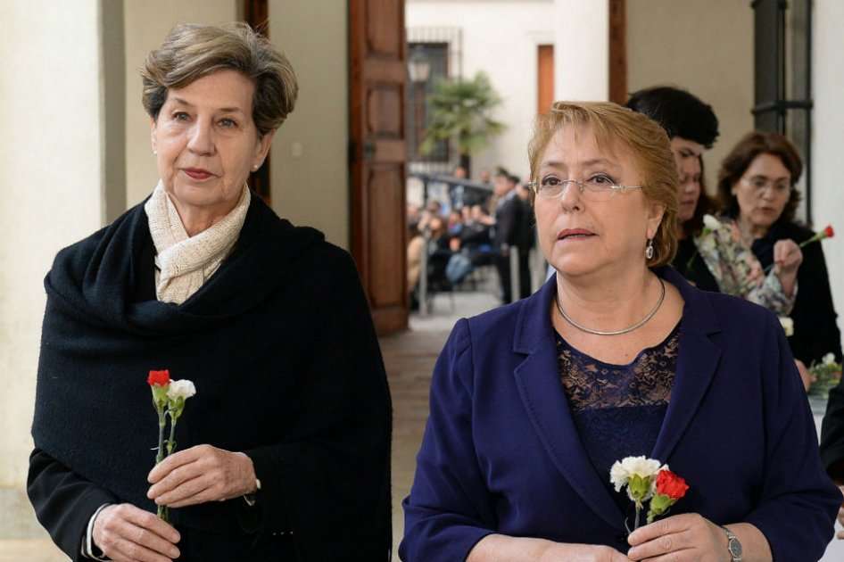 La actual presidente Michelle Bachelet (derecha), junto a la senadora Isabel Allende (izquierda), antes de dejar unas flores en las Placas Recordatorias de lo ocurrido el 11 de septiembre de 1973, cuando el presidente Salvador Allende, falleció mientras el Palacio de La Moneda era ocupado por las fuerzas militares de la dictadura. / Presidencia de Chile- EFE