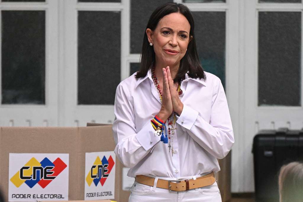 (FILES) Venezuelan opposition leader Maria Corina Machado gestures as she votes during the presidential election, in Caracas on July 28, 2024.