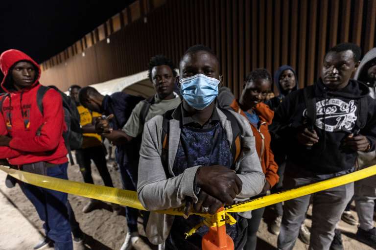 Yuma (United States), 12/05/2023.- Papa Samb, a Senegalese migrant, stands with compatriots while waiting to be processed by Border Patrol officers after crossing from Mexico to the United States, in Yuma, Arizona, USA, 11 May 2023. A significant increase in the number of migrants crossing is expected as the Covid-era Title 42 policy, which allowed for a quick expulsion of illegal immigrants, is set to expire 11 May. (Disturbios, Estados Unidos) EFE/EPA/ETIENNE LAURENT