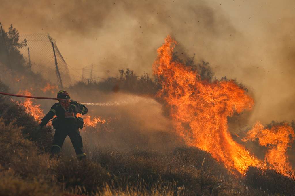 Firemen battle with a wildfire that broke out in Ierapetra at the southern Greek island of Crete, on July 3, 2025.