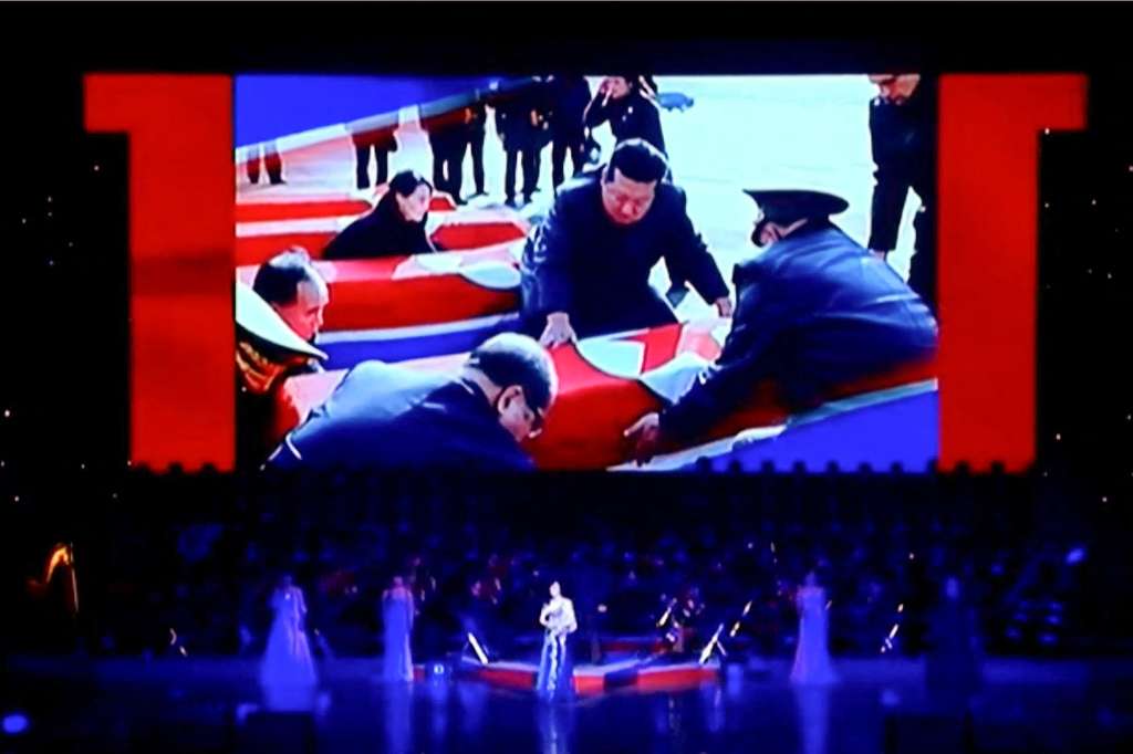 This frame grab from Korean Central Television (KCTV) taken on June 29, 2025 and released via AFPTV on July 1 shows a screen displaying North Korea's leader Kim Jong Un looking at coffins during a performance attended by Kim and Russian Minister of Culture Olga Lyubimova in Pyongyang.