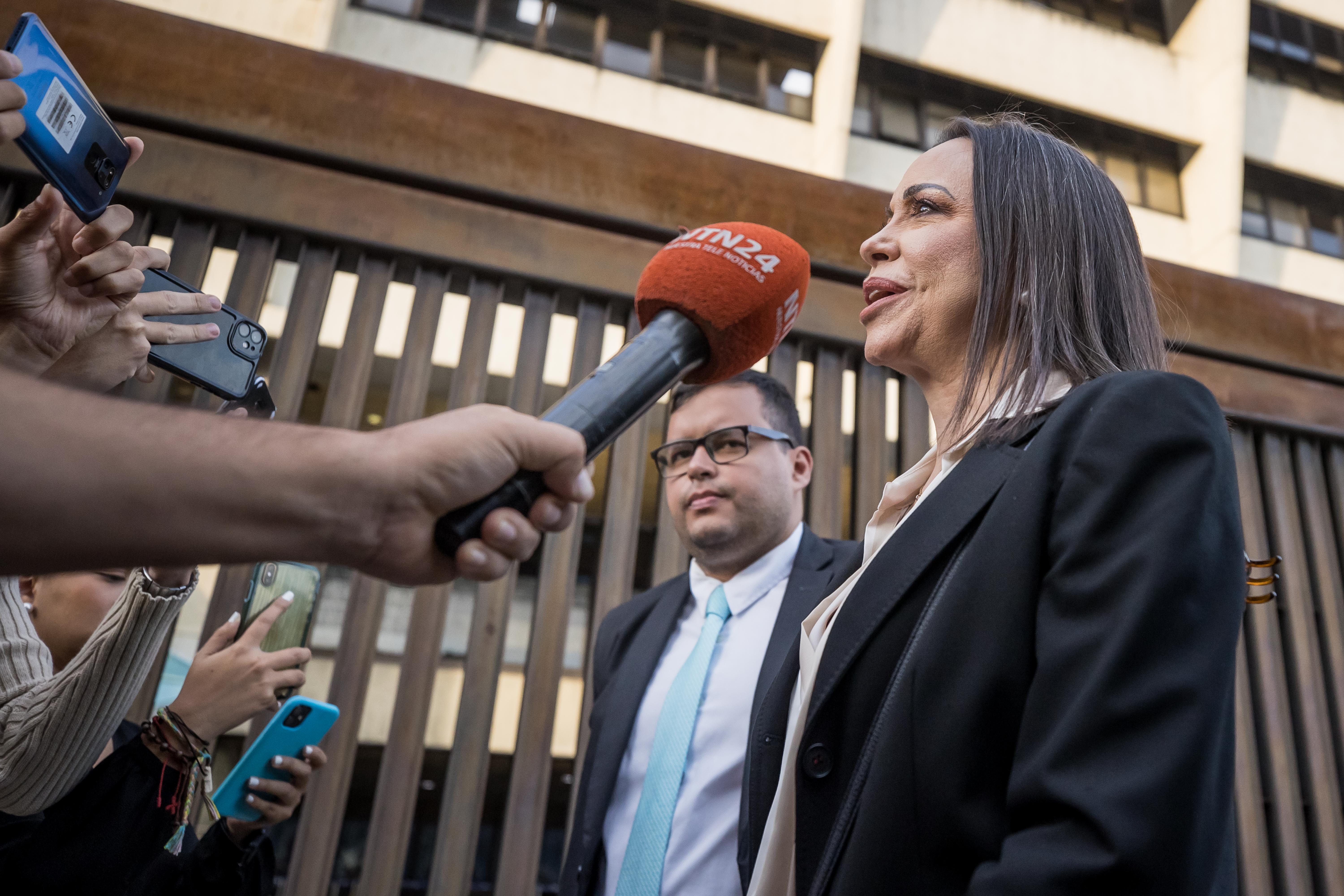 AME4581. CARACAS (VENEZUELA), 15/12/2023.- María Corina Machado habla con periodistas en la salida del Tribunal Supremo de Justicia, hoy en Caracas (Venezuela). La candidata presidencial de la principal coalición opositora de Venezuela, María Corina Machado, solicitó al Tribunal Supremo de Justicia (TSJ) revisar la inhabilitación que le impide competir para ocupar cargos de elección popular, corroboró este viernes EFE. EFE/ Miguel Gutiérrez