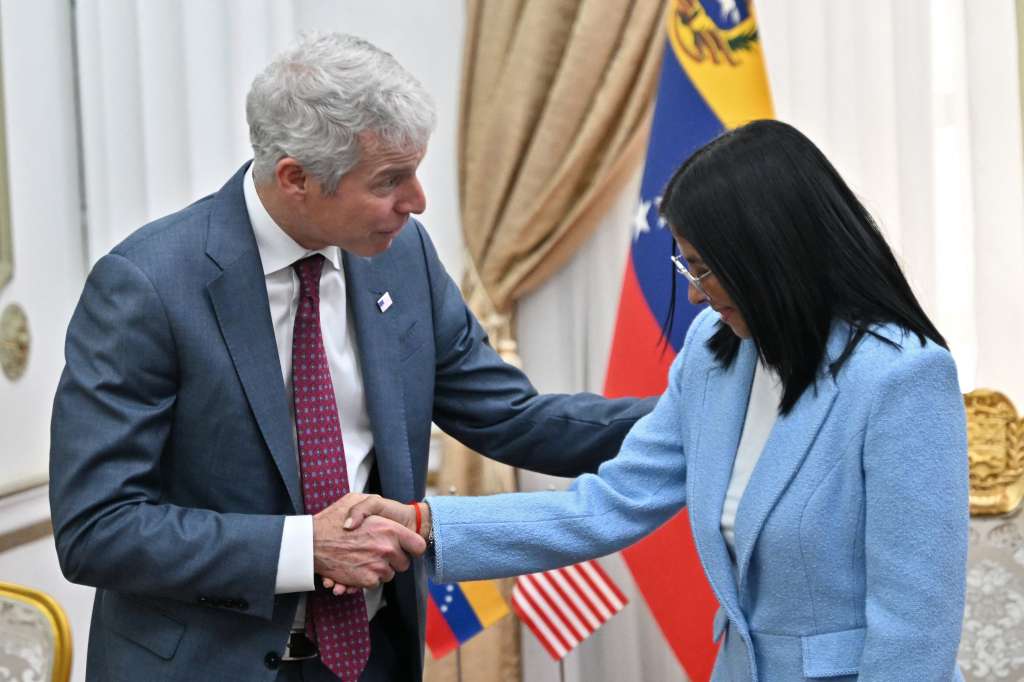 US Secretary of Energy Chris Wright (L) shakes hands with Venezuela's acting president Delcy Rodriguez before a meeting at the Miraflores Presidential Palace in Caracas on February 11, 2026. US Energy Secretary Chris Wright arrived in Venezuela on February 11 for talks with acting president Delcy Rodriguez and oil industry executives on harnessing the country's vast crude reserves. (Photo by Juan BARRETO / AFP)