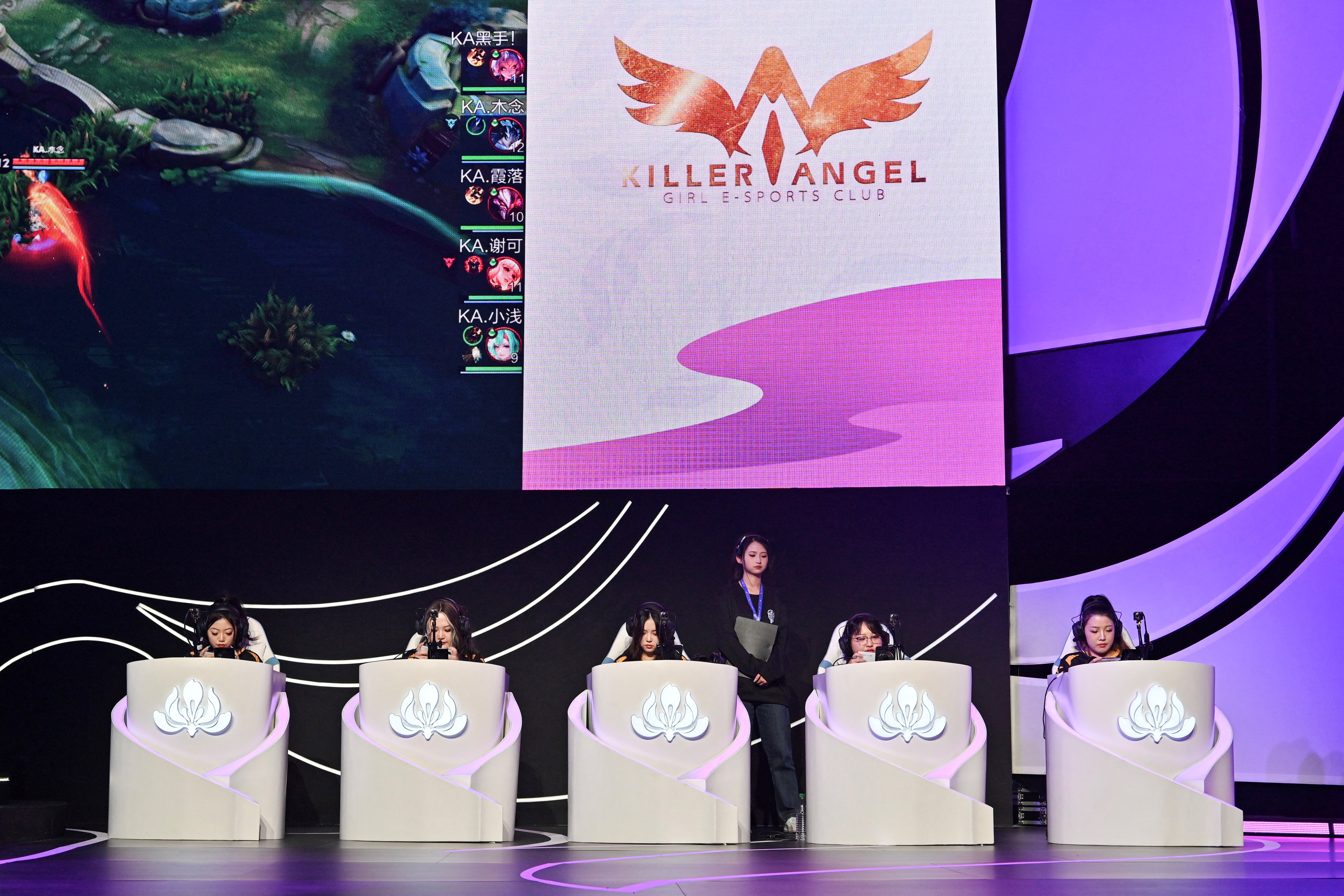 This picture taken on December 19, 2024 shows female gamers competing during a women's e-sport event in Beijing.