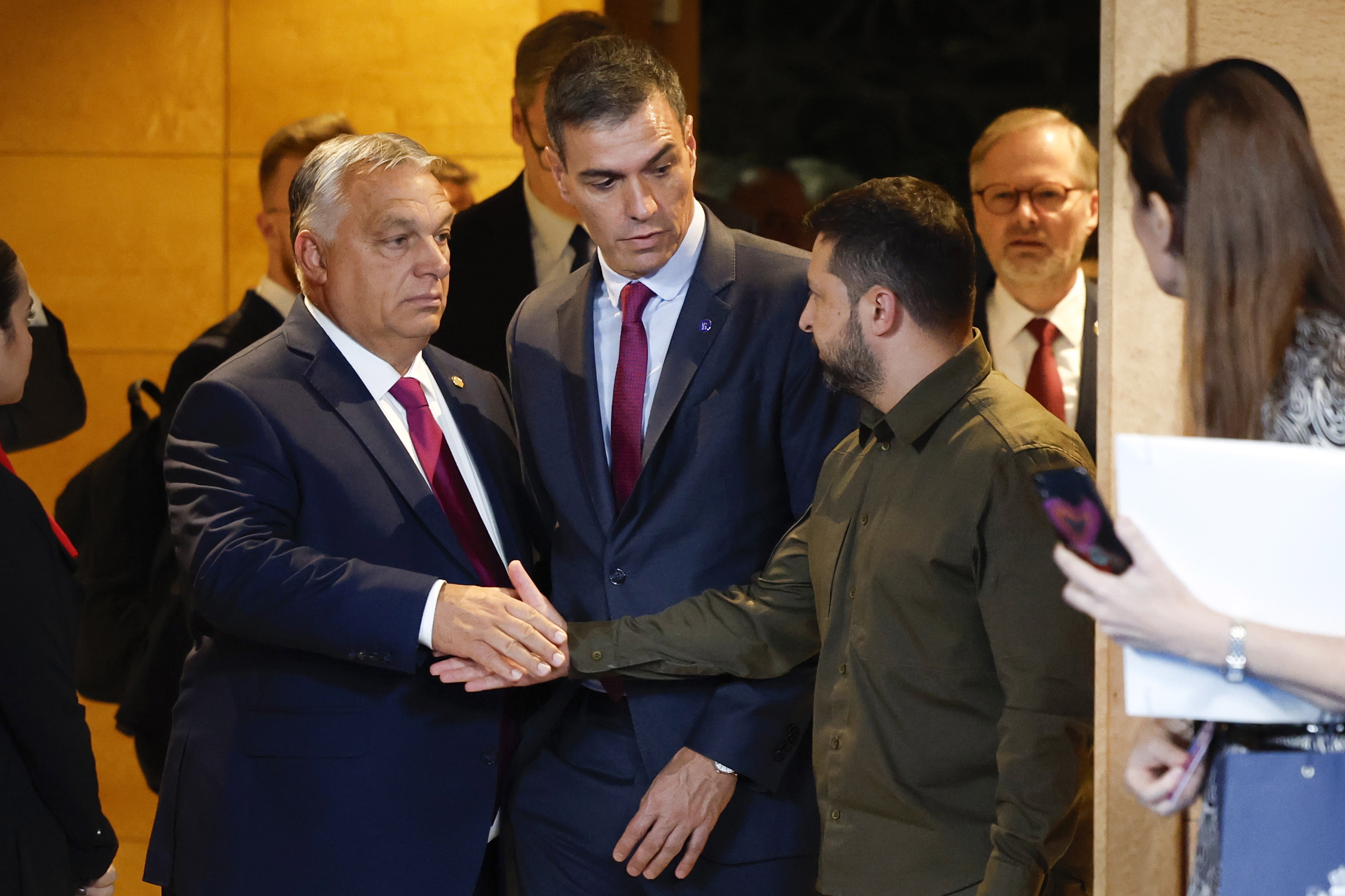 Granada (Spain), 05/10/2023.- Prime Minister of Hungary Viktor Orban (L) and President of Ukraine Volodymyr Zelensky (R) shake hands beside Spain's Prime Minister Pedro Sanchez (C) prior to the opening ceremony of the third meeting of the European Political Community (EPC) Summit at the Congress Hall in Granada, Spain, 05 October 2023. (Hungría, España, Ucrania) EFE/EPA/PETER KLAUNZER