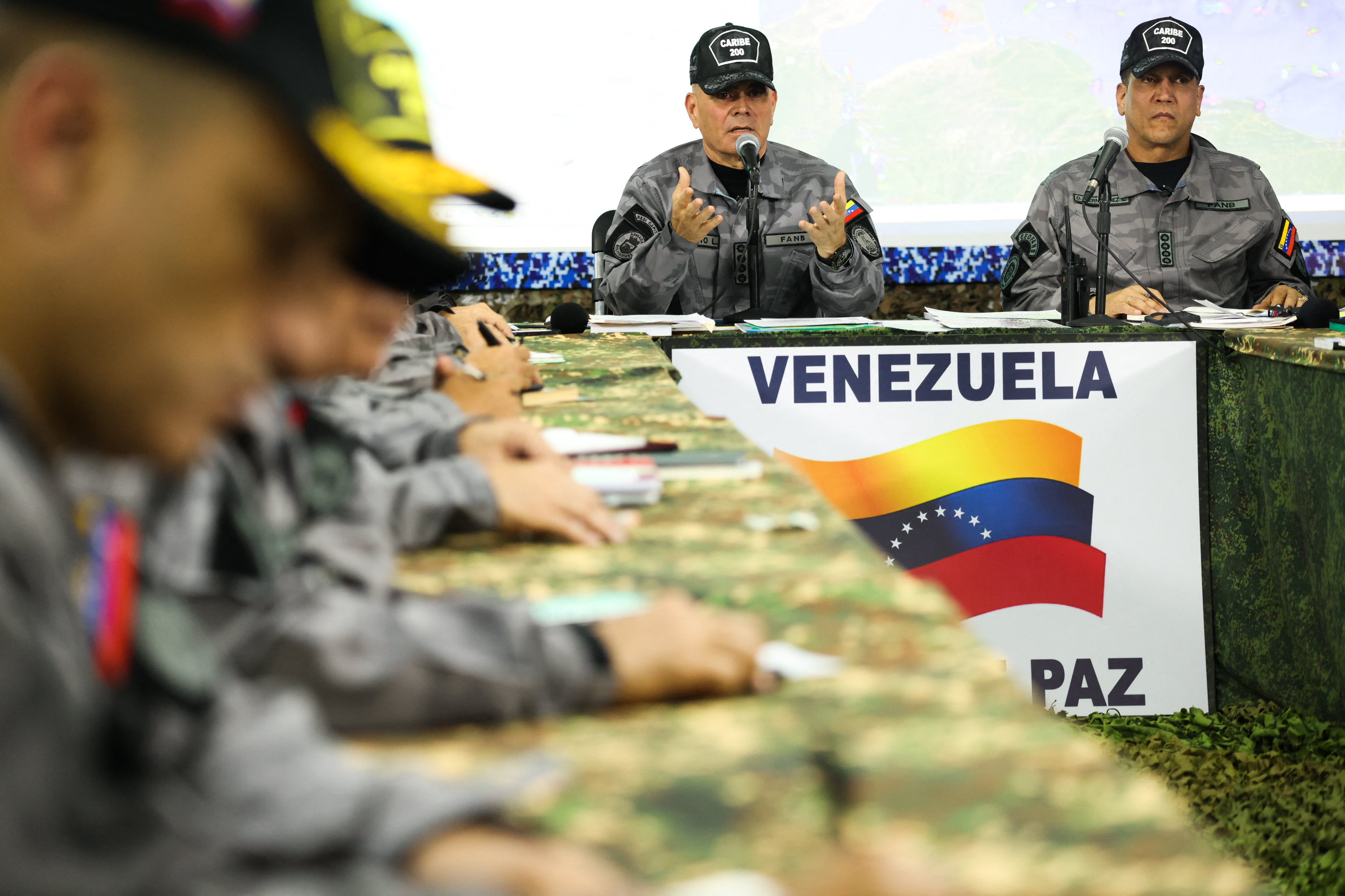 This handout picture released by the Venezuelan Presidency on September 17, 2025, shows Venezuela's Defense Minister Vladimir Padrino (L) speaking in a meeting with the Military High Command in Caracas. Venezuela said on September 17, 2025, it had begun three days of military exercises on its Caribbean isl