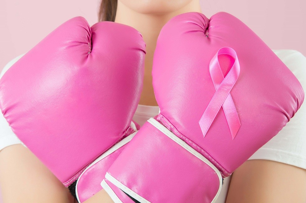 Chinese girl wear boxing gloves crossed arms