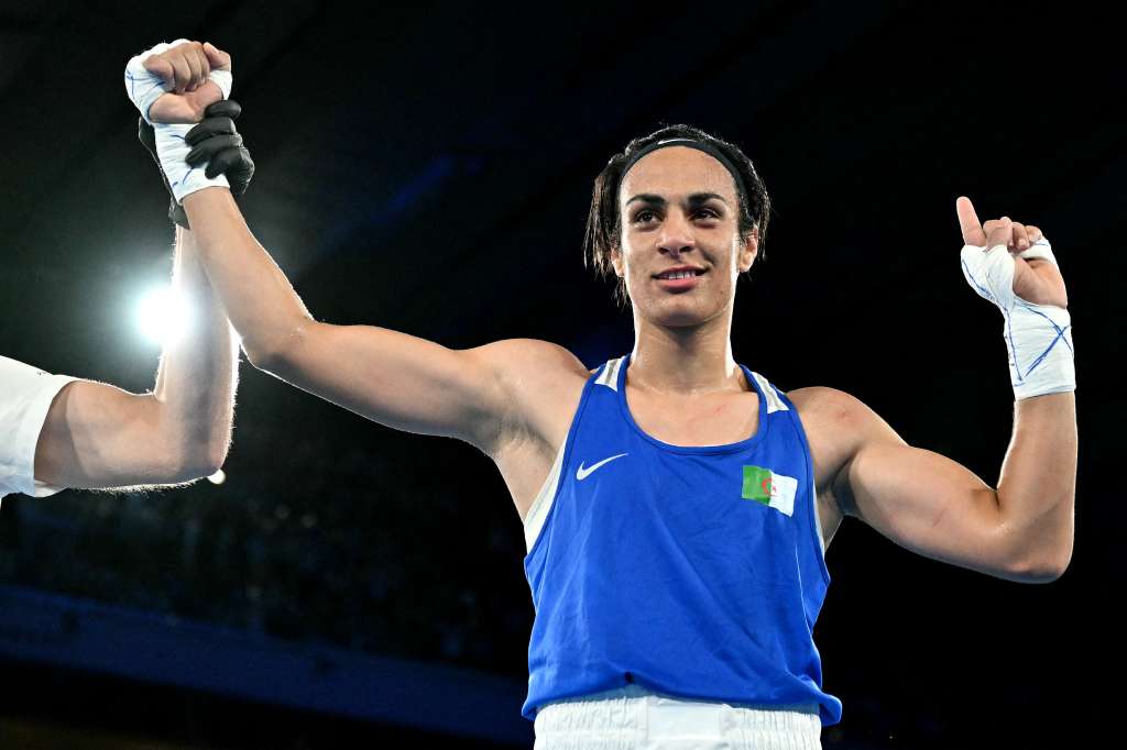 (FILES) Algeria's Imane Khelif (Blue) reacts after beating Thailand's Janjaem Suwannapheng in the women's 66kg semi-final boxing match during the Paris 2024 Olympic Games at the Roland-Garros Stadium, in Paris on August 6, 2024.
