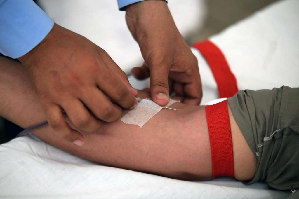 Peshawar (Pakistan), 14/06/2024.- A man donates blood at Al-Khidmat hospital, on the World Blood Donor Day, in Peshawar, Pakistan, 14 June 2024. World Blood Donor Day is celebrated annually around the world on 14 June to raise awareness of the need for safe blood and to thank blood donors. The theme for World Blood Donor Day 2024 is: '20 years of celebrating giving: thank you blood donors'. EFE/EPA/ARSHAD ARBAB