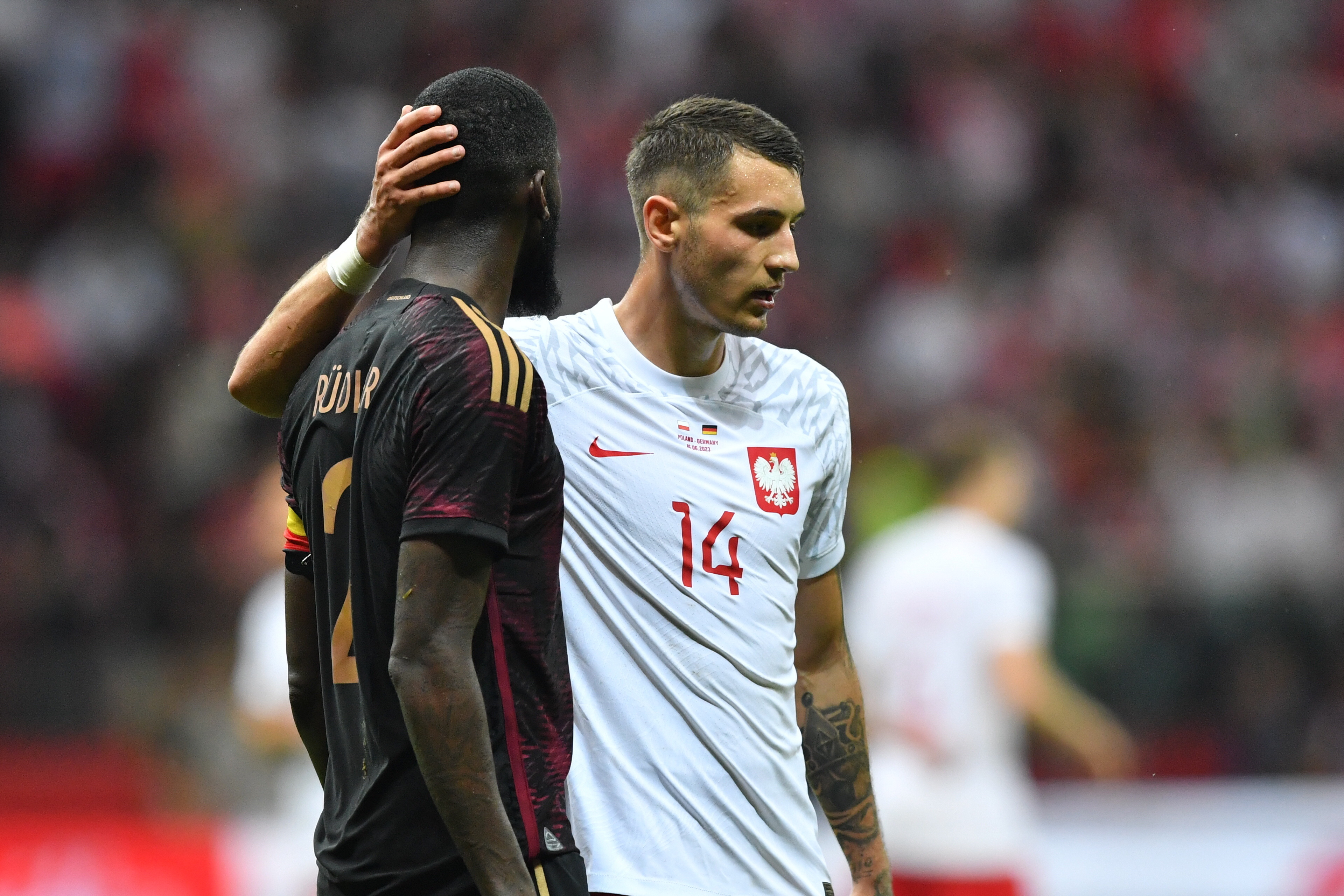 Warsaw (Poland), 16/06/2023.- Poland's Jakub Kiwior (R) and Germany's Antonio Ruediger (L) react during a soccer friendly match between Poland and Germany in Warsaw, Poland, 16 June 2023. (Futbol, Amistoso, Alemania, Polonia, Varsovia) EFE/EPA/Piotr Nowak POLAND OUT