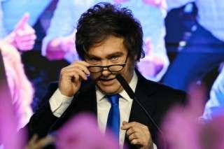 (FILES) Argentina's President Javier Milei gestures at the ruling party's La Libertad Avanza headquarters following the results of the national midterm legislative election in Buenos Aires on October 26, 2025.
