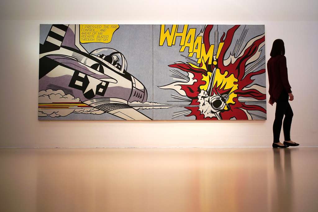 LONDON, ENGLAND - FEBRUARY 05: A gallery assistant views the restored artwork Whaam! by Roy Lichtenstein in Tate Liverpool on February 5, 2018 in London, England. Lichtenstein's iconic 1963 painting Whaam! has been restored using recently discovered nano technology. The painting has been on constant loan and display since Tate Modern aquired the work in 1966 and was in need of conservation work. The painting is part of Tate Liverpool's 30th anniversary celebrations. (Photo by Christopher Furlong/Getty Images)