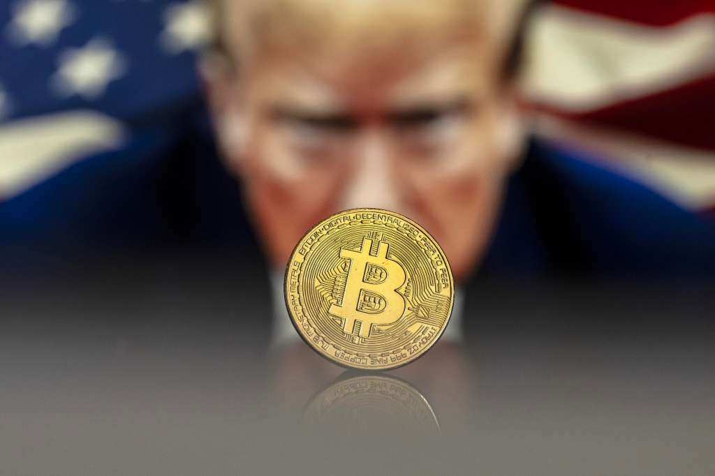 Lugano (Switzerland), 22/11/2024.- (FILE) - An illustration shows a Bitcoin mockup in front of an image of US President-elect Donald Trump, 22 November 2024 (reissued 16 December 2024). The world's most popular cryptocurrency hit a new record high on 16 December 2024, briefly passing 106,000 dollars (100,800 euros). (Suiza) EFE/EPA/PABLO GIANINAZZI