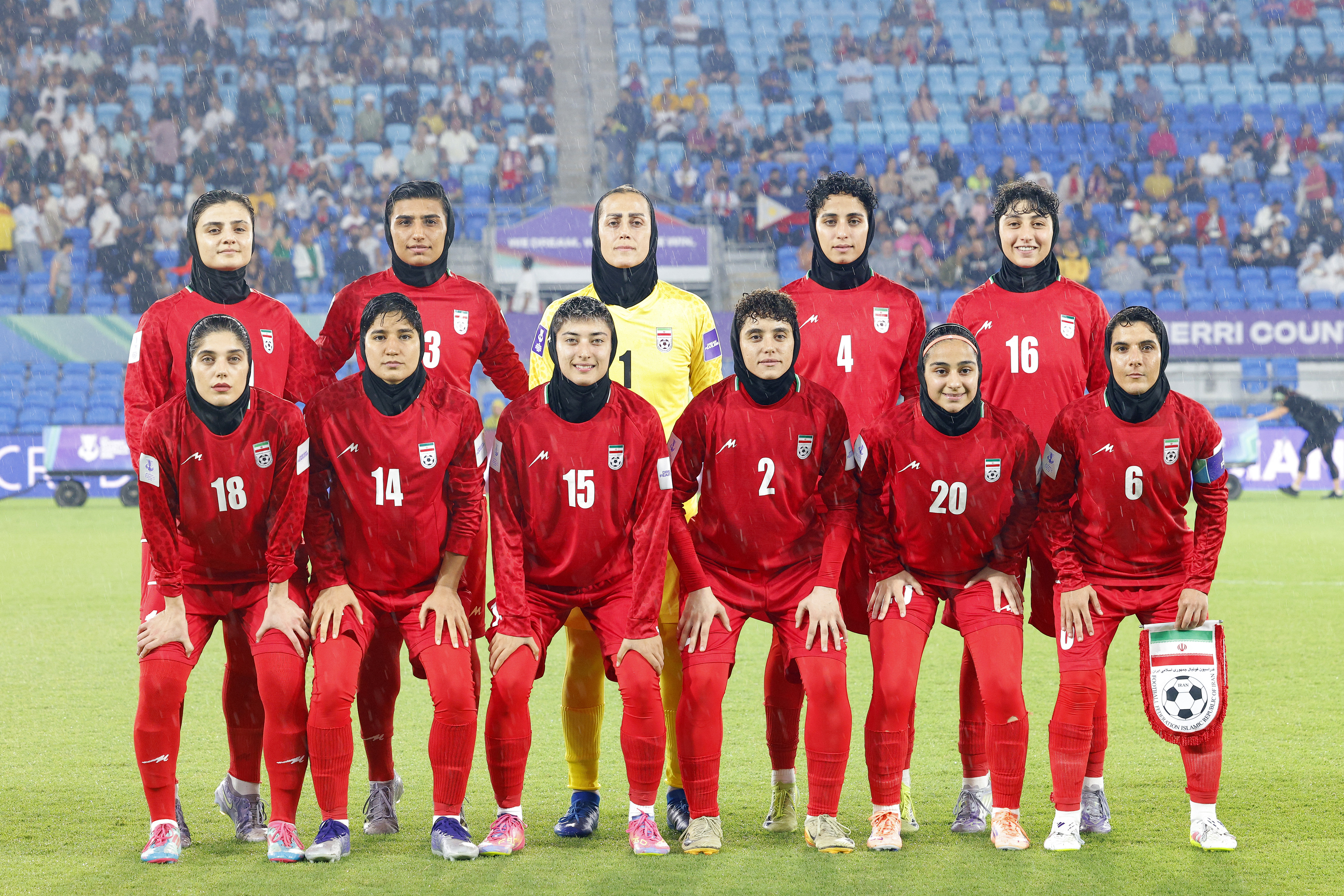 Iran�s team pose for a group photo before the AFC Women�s Asian Cup Australia 2026 match between Iran and the Philippines in Gold Coast on March 8, 2026. The son of the late shah urged Canberra on March 9 to protect the Iranian women's football team, who were branded "wartime traitors" after refusing to sing the national anthem while playing in Australia. (Photo by AFP) / -- IMAGE RESTRICTED TO EDITORIAL USE - STRICTLY NO COMMERCIAL USE --