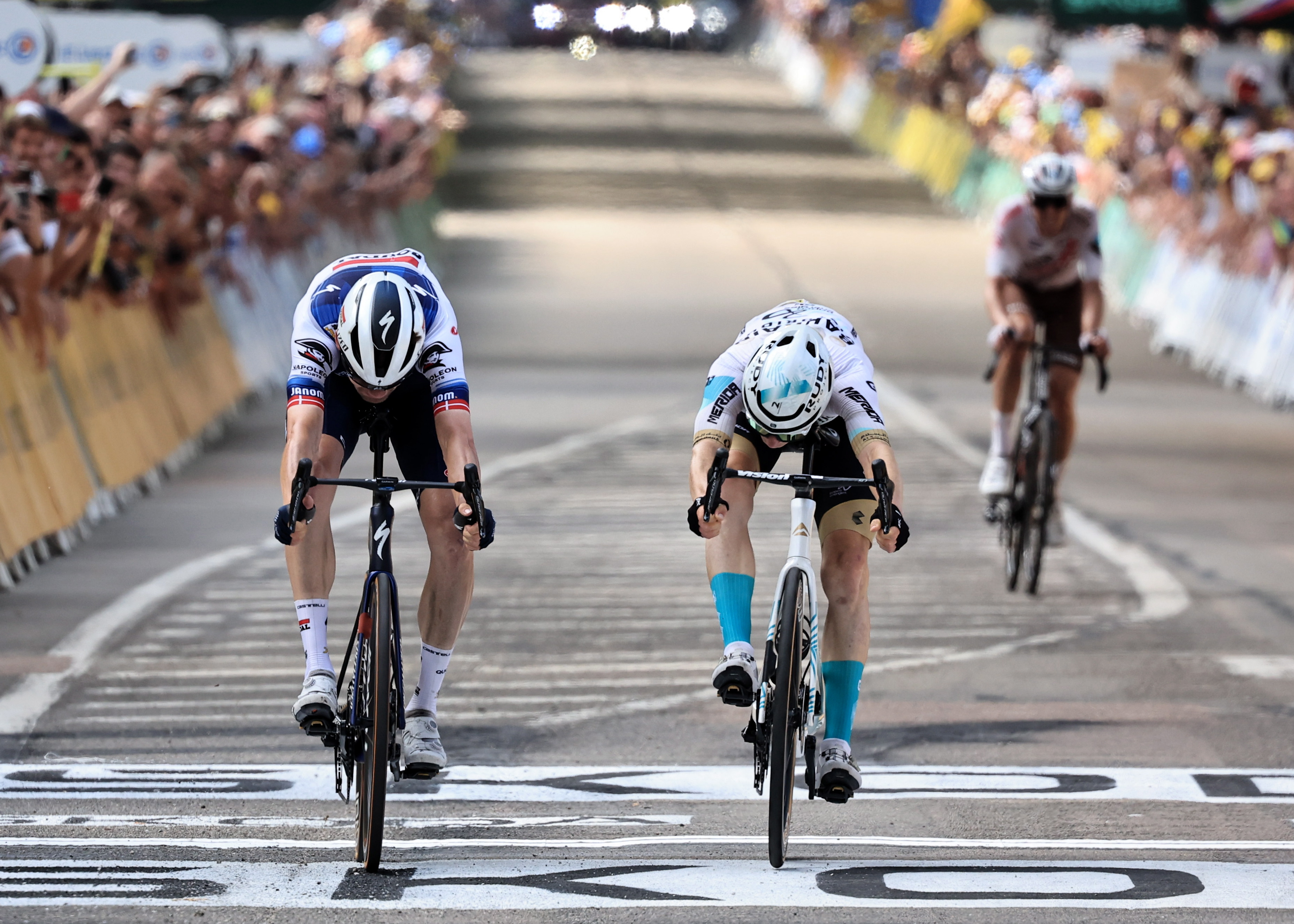 Poligny (France), 21/07/2023.- Second placed Danish rider Kasper Asgreen (L) of team Soudal-Quick Step and first placed Slovenian rider Matej Mohoric (C) of team Bahrain-Victorious cross the finish line during the 19th stage of the Tour de France 2023, a 173kms race from Moirans-en-Montagne to Poligny, France, 21 July 2023. (Ciclismo, Bahrein, Francia, Eslovenia) EFE/EPA/MARTIN DIVISEK