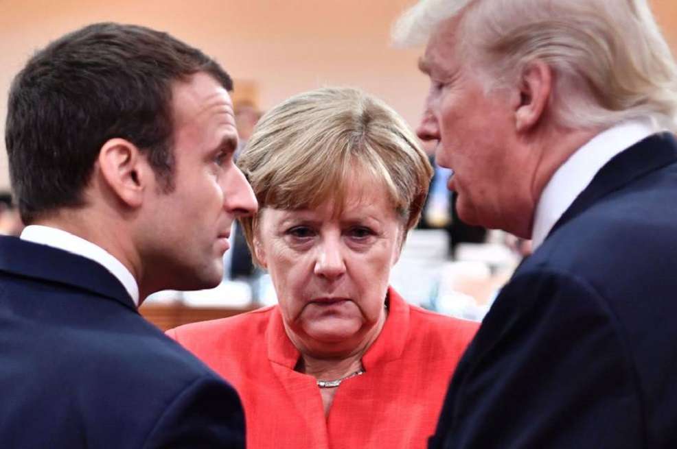 Emmanuel Macron, Angela Merkel y Donald Trump. / AFP