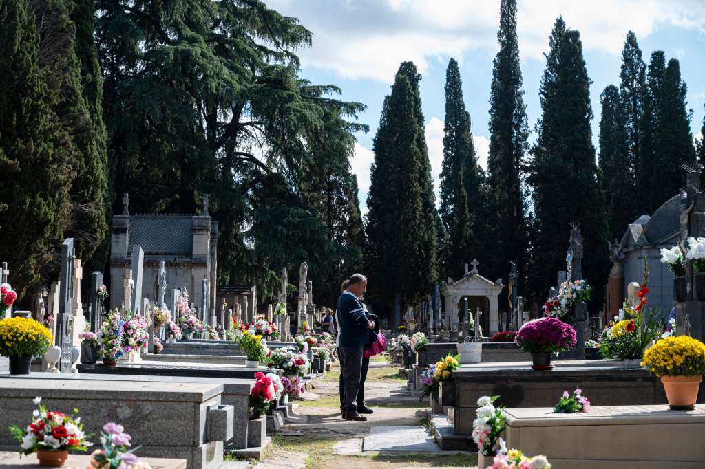 ALCALÁ DE HENARES (MADRID), 01/11/2022.- Dos personas visita la tumba de un ser querido en el Cementerio Viejo de Alcalá de Henares, este martes, Día de Todos los Santos. EFE/ Fernando Villar