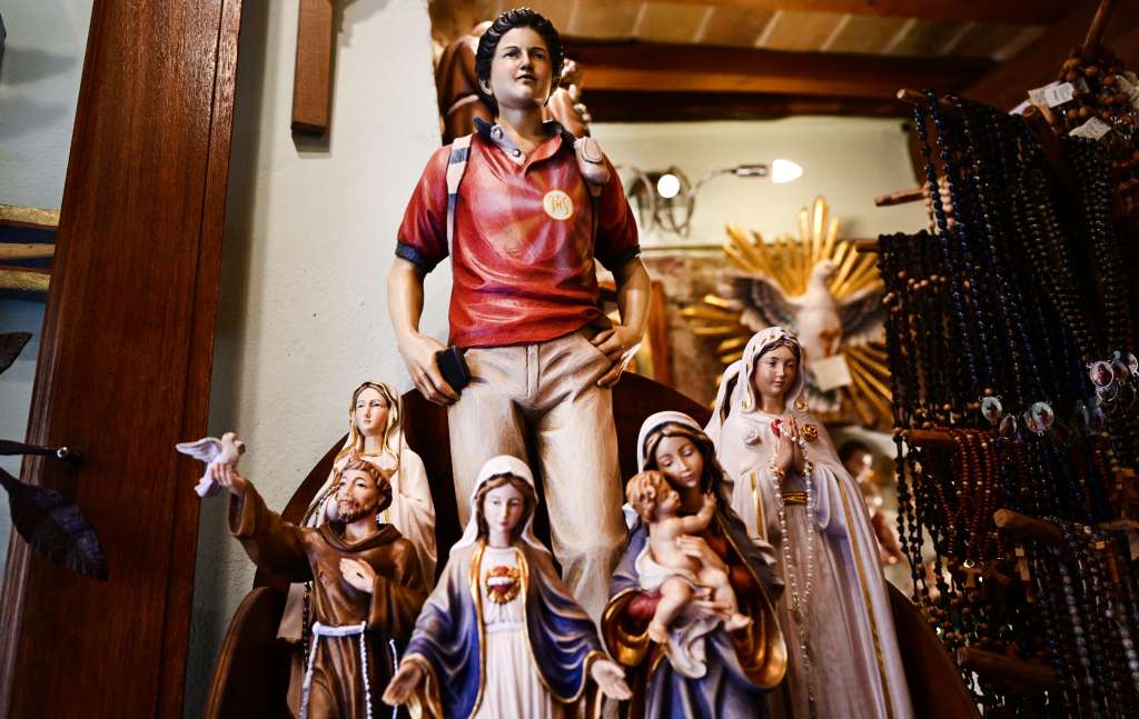 Figurines of Blessed Carlo Acutis, an adolescent who spent his life spreading his faith online, earning the moniker "God's Influencer", are on sale in a souvenirs shop in Assisi where Acutis is on display, on April 3, 2025.