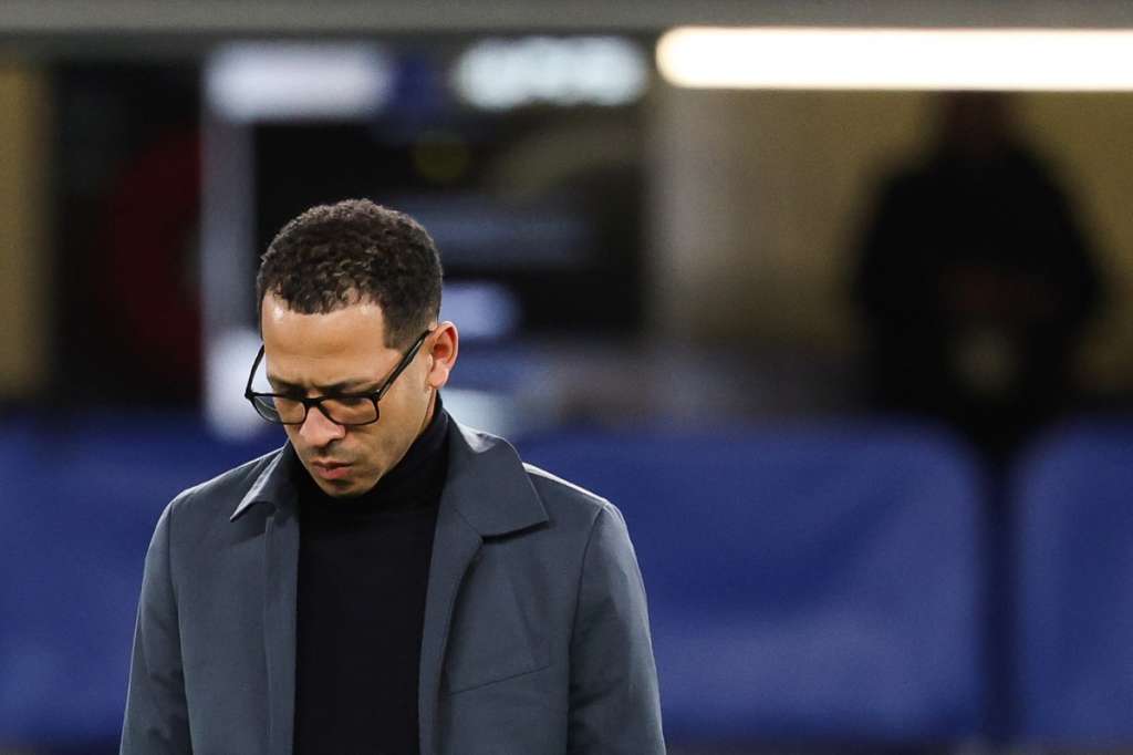 (FILES) Chelsea's English head coach Liam Rosenior looks down ahead of the UEFA Champions League round of 16 second leg football match between Chelsea FC and Paris Saint-Germain (PSG) at Stamford Bridge, west London on March 17, 2026.