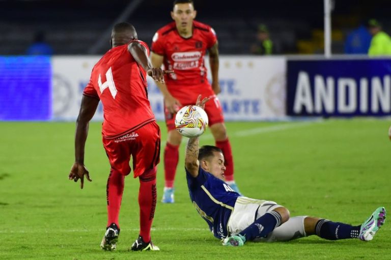 Los jugadores de América y Millonarios disputan una pelota en El Campín.