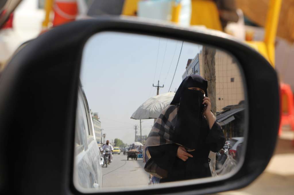 Kandahar (Afghanistan), 22/08/2024.- A Burqa-clad Afghan woman walks on a road in Kandahar, Afghanistan, 22 August 2024. The Taliban in Afghanistan have enforced new laws mandating that women must cover their bodies and faces in public, citing these measures as necessary to promote virtue and prevent vice, the Ministry for the Propagation of Virtue and Prevention of Vice said. Approved by their Supreme Leader Hibatullah Akhundzada, the regulations include restrictions on women's voices in public, the prohibition of images of living beings, and bans on music and mixed-gender interactions. The measures have drawn criticism from the United Nations (UN) for fostering fear and intimidation, especially among women and girls, as the Taliban's Ministry for the Propagation of Virtue and Prevention of Vice expands its control over public life. (Afganistán) EFE/EPA/QUDRATULLAH RAZWAN