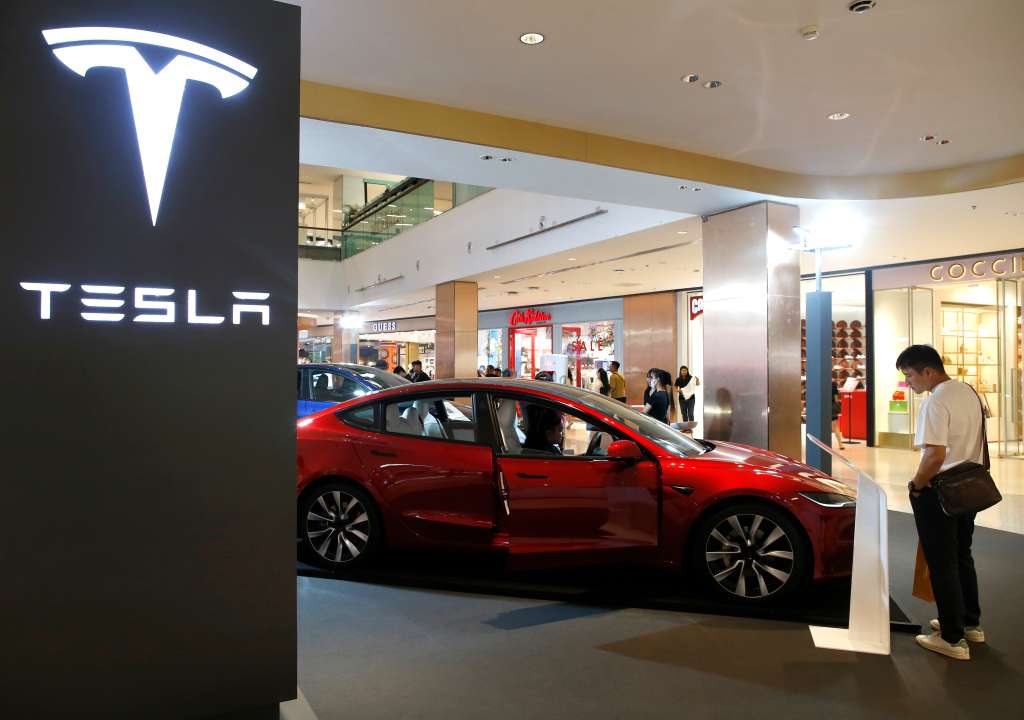 Bangkok (Thailand), 24/06/2024.- Visitors inspect a Tesla electric car displayed for sale at a shopping mall in Bangkok, Thailand, 24 June 2024. The US electric vehicle maker Tesla has launched a special rate program for Model 3 and Model Y in Thailand aimed at boosting its sales and compete with Chinese made electric vehicles. (Tailandia) EFE/EPA/RUNGROJ YONGRIT