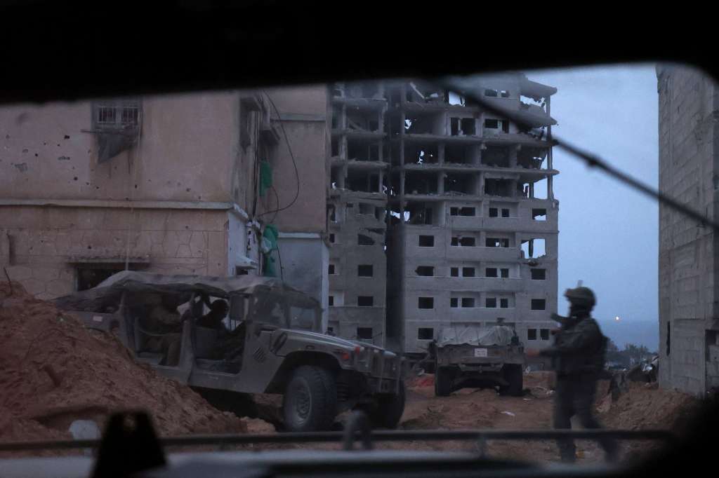 Jabalia (-), 08/12/2023.- A photo taken while embedded with the Israel Defense Forces (IDF) shows Israeli soldiers with military vehicles at a position in the Palestinian refugee camp of Jabalia, on the outskirts of the city of Gaza, northern Gaza Strip, 08 December 2023. Israeli forces resumed military strikes on Gaza after a week-long truce expired on 01 December. More than 16,200 Palestinians and at least 1,200 Israelis have been killed, according to the Palestinian Health Ministry and the Israel Defense Forces (IDF), since Hamas militants launched an attack against Israel from the Gaza Strip on 07 October, and the Israeli operations in Gaza and the West Bank which followed it. The Israeli military stated that its forces are involved in 'ground operations' against Hamas in the Gaza Strip, including the south of the enclave. EFE/EPA/ATEF SAFADI