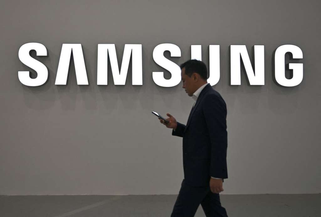 (FILES) A visitor walks past the logo of Samsung Electronics during the Korea Electronics Show 2025 at the COEX convention and exhibition centre in Seoul on October 22, 2025.