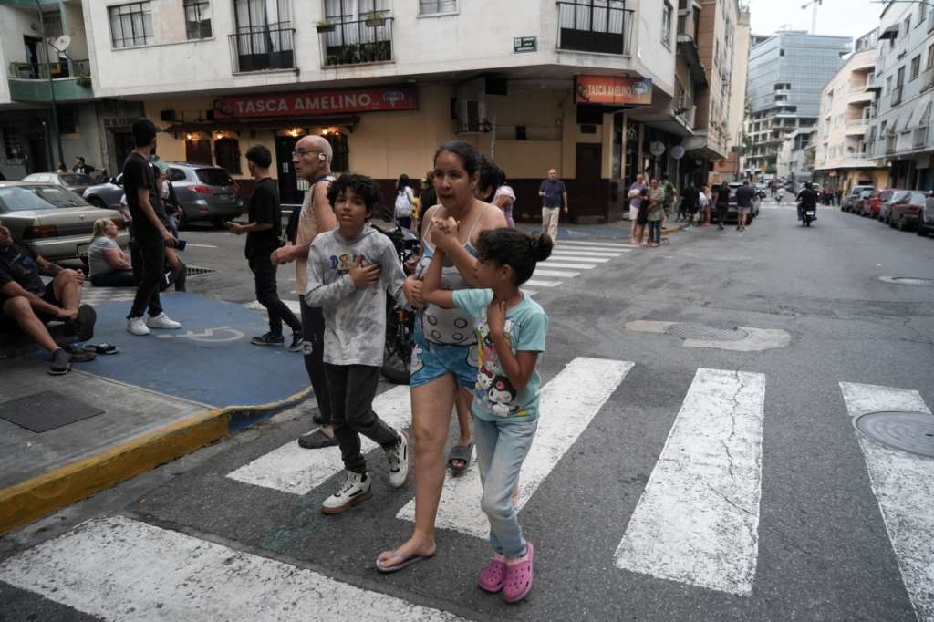 People remain on a street following an earthquake in Caracas on June 24, 2026.