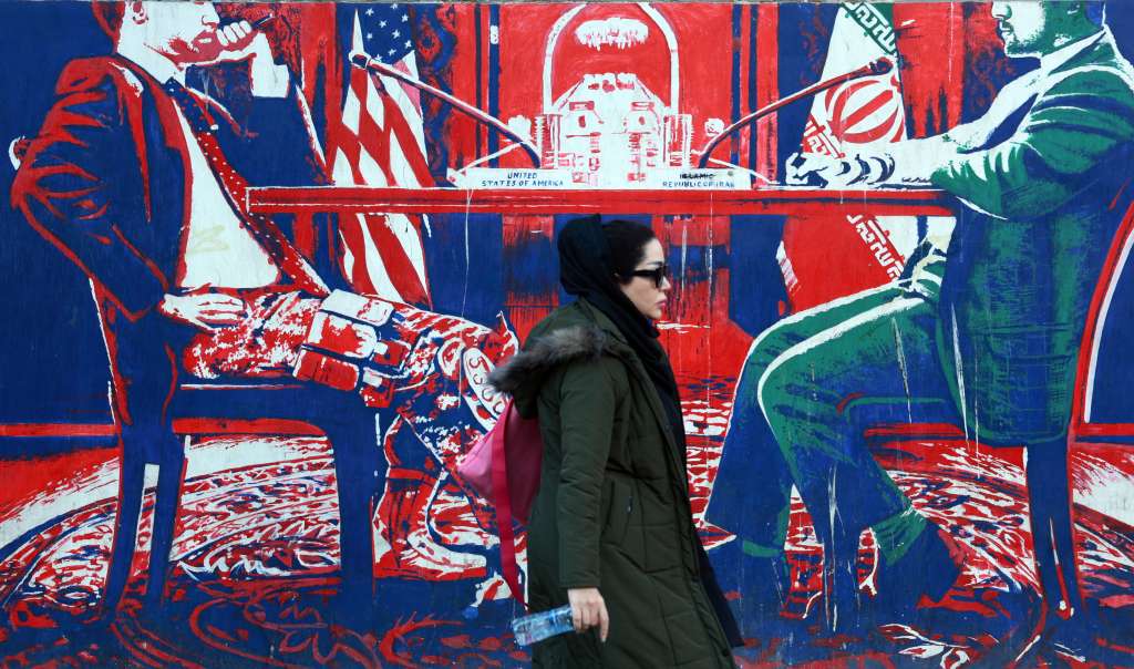 Tehran (Iran(islamic Republic Of)), 06/11/2024.- An Iranian woman walks past an anti-US mural near the former US embassy in Tehran, Iran, 06 November 2024. The Republican candidate for president Donald J. Trump, has been elected as the 47th President of the United States after obtaining over 270 of the Electoral College votes, succeeding against Democratic candidate and current Vice President Kamala Harris. (Elecciones, Estados Unidos, Teherán) EFE/EPA/ABEDIN TAHERKENAREH