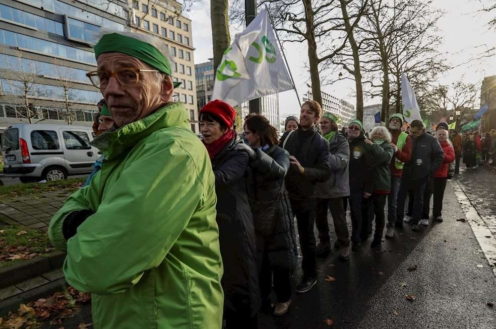 Ambientalistas forman una cadena humana mientras hacen parte de una movilización contra la crisis climática, en Bruselas, en el marco de la COP25. / EFE