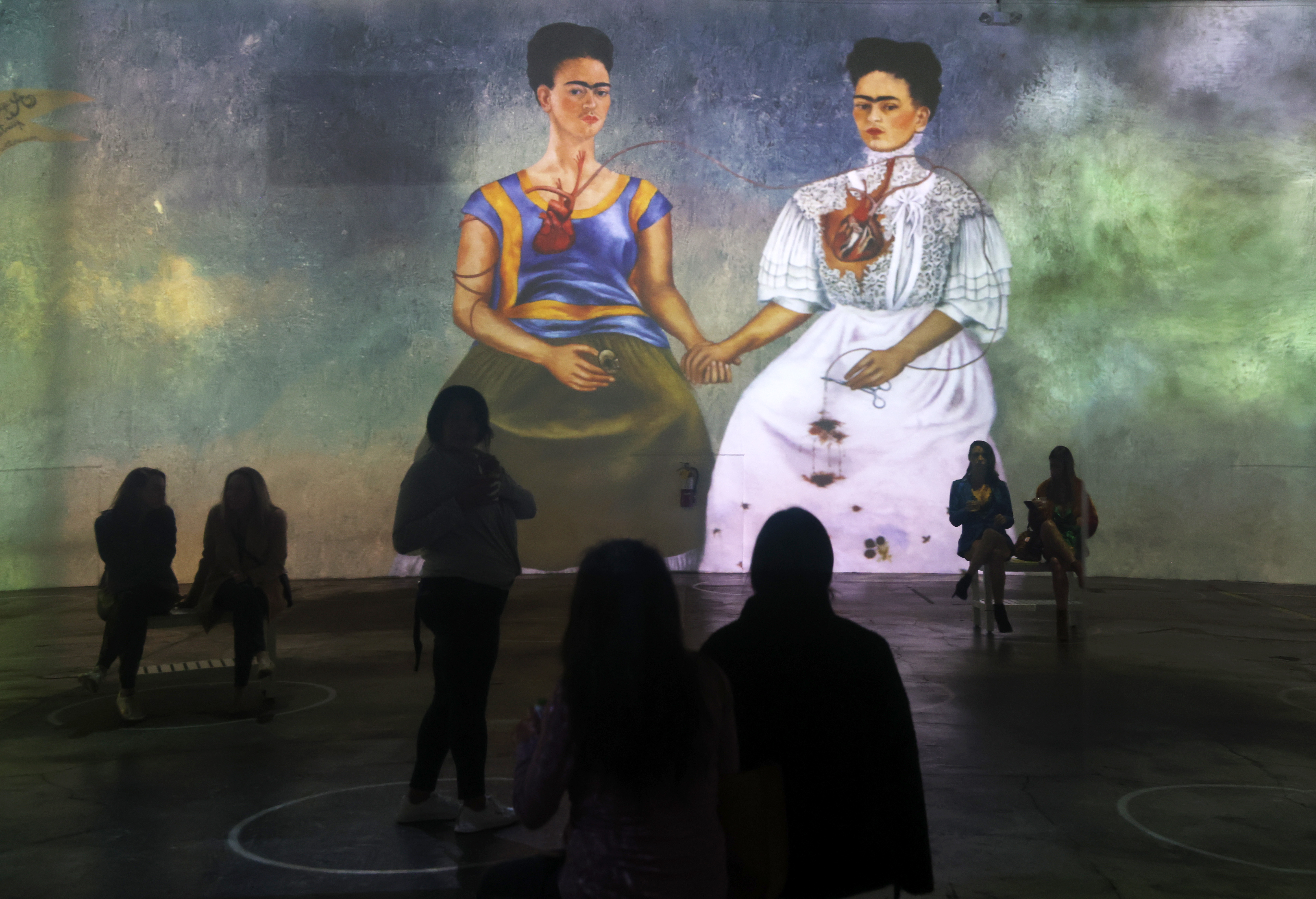 SAN FRANCISCO, CALIFORNIA - MARCH 11: Guests view the Immersive Frida Kahlo Exhibit during a media preview at SVN West on on March 11, 2022 in San Francisco, California. “Immersive Frida Kahlo,” is a digitally projected show that animates paintings by Mexican artist Frida Kahlo in a surroundscape experience. The show opens on March 12 and will run through June 11.