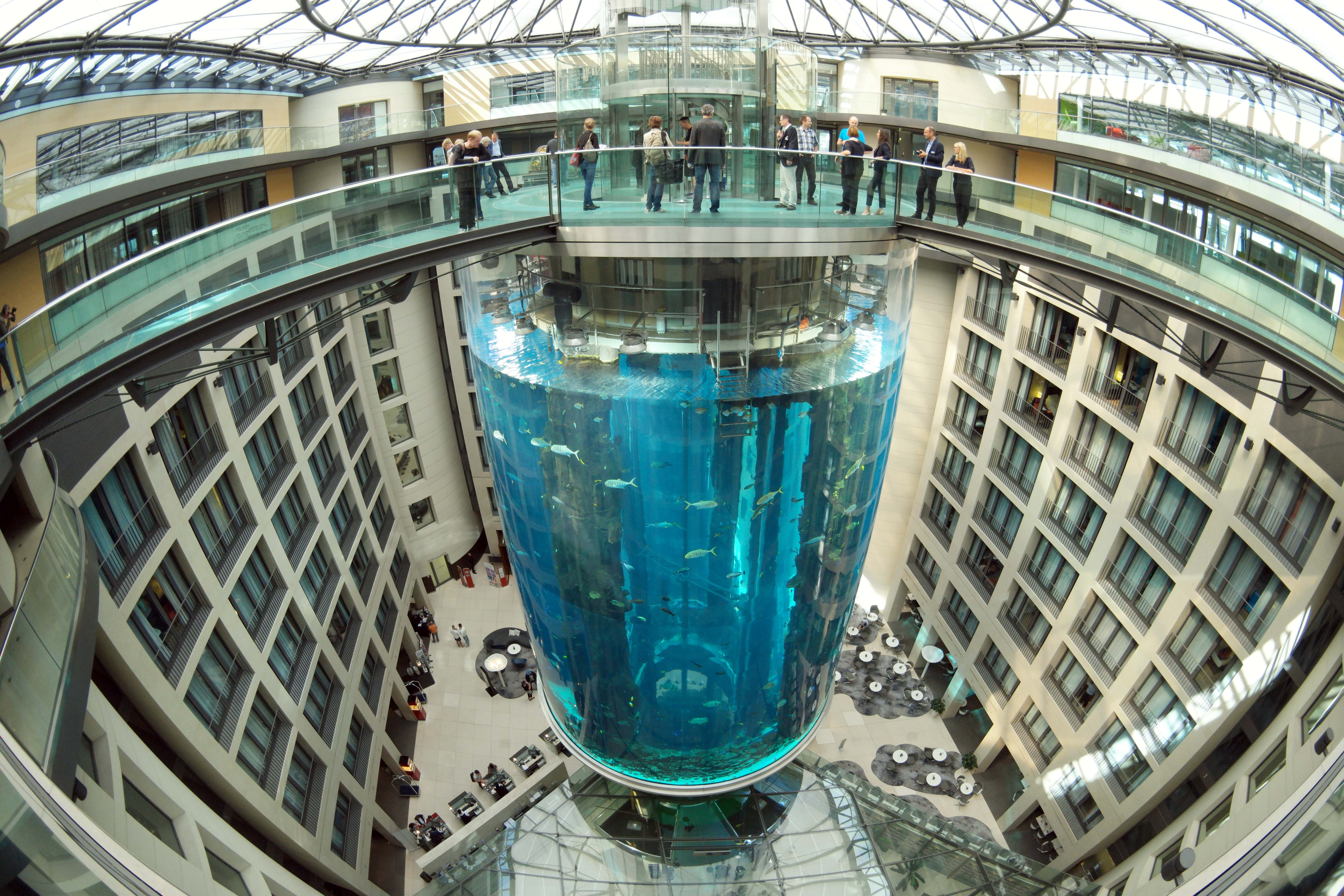 (FILE) A view of the AquaDom, the largest freestanding cylindrical aquarium in the world located in Berlin, Germany, 29 July 2015 (re-issued on 16 December). A 14-meter aquarium has burst at a hotel in downtown Berlin, injuring two people, German rescue services said on 16 December 2022. The home to around 1,500 exotic fish spills 1 million liters of water and floats a major road in the Mitte district, emergency services said. EPA/JOERG CARSTENSEN
