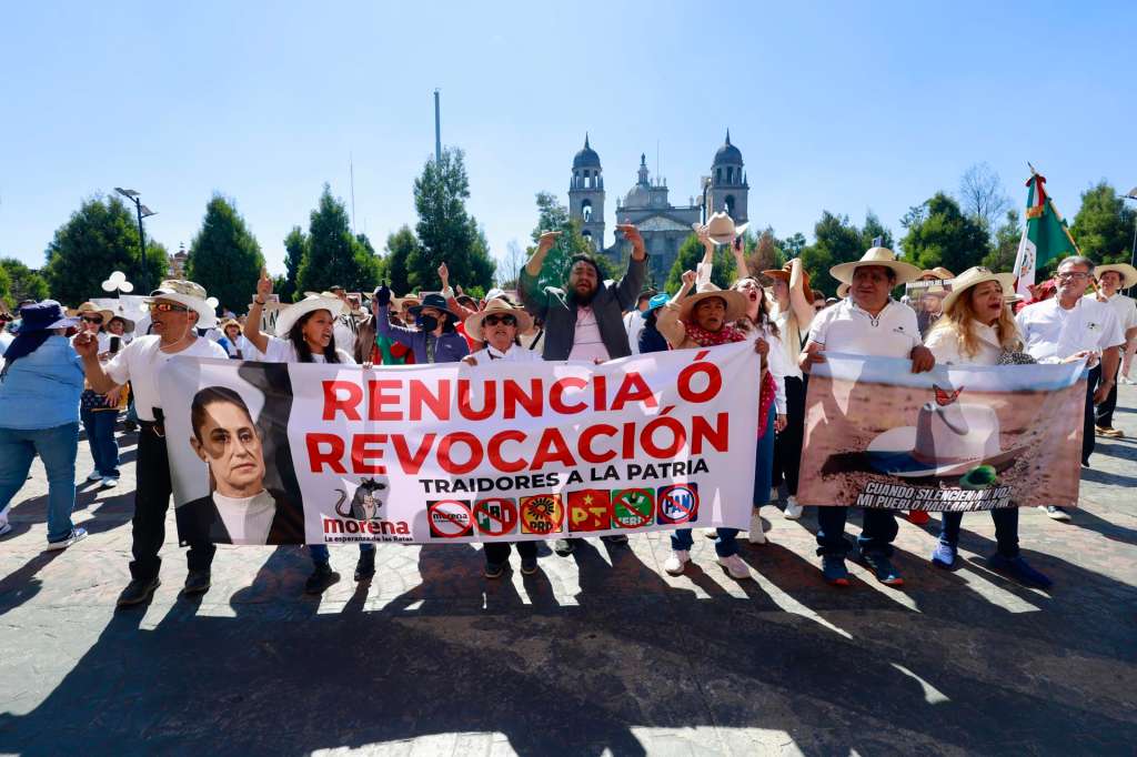 People holding a sign in a protest in the city of Toluca, Mexico, 15 November 2025. Waving flags and chanting “Claudia (Sheinbaum) must go!”, hundreds of Mexicans protested to express their “political weariness” with the government led by the Mexican president and denounce the “impunity” in the face of the violence plaguing the country. EFE/ Felipe Gutierrez