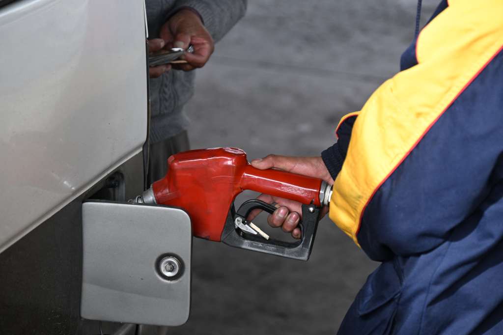 A gas station worker refuels a vehicle in La Paz on November 12, 2025.
