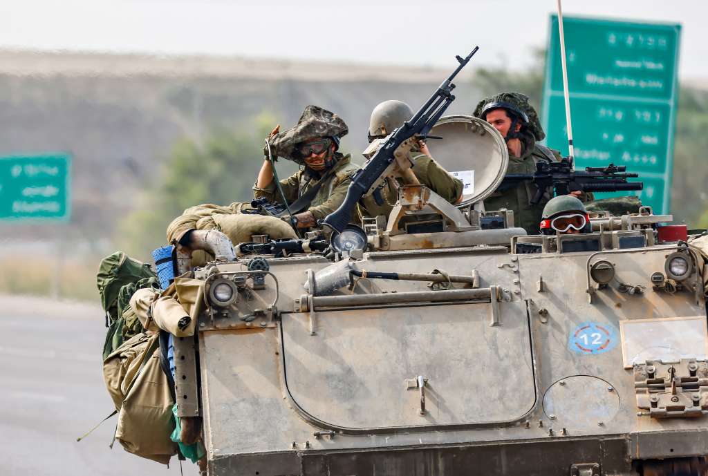 Undisclosed (Israel), 29/10/2023.- Israeli soldiers drive with an armoured personnel carrier (APC) while on patrol near the border with Gaza, in Israel, 29 October 2023. The IDF conducted targeted raids in the Gaza Strip on 28 October and struck dozens of targets belonging to the Hamas militants, the IDF confirmed. More than 7,600 Palestinians and at least 1,300 Israelis have been killed, according to the IDF and the Palestinian health authority, since Hamas militants launched an attack against Israel from the Gaza Strip on 07 October, and the Israeli operations in Gaza and the West Bank which followed it. EFE/EPA/HANNIBAL HANSCHKE EPA-EFE/HANNIBAL HANSCHKE