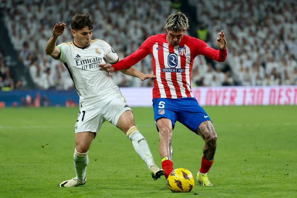 MADRID, 04/02/2024.- El centrocampista del Real Madrid Brahím (i), pelea un balón con el centrocampista argentino del Atlético de Madrid Rodrigo de Paul durante el partido de LaLiga de fútbol que Real Madrid y Atlético de Madrid disputan este domingo en el estadio Santiago Bernabéu. EFE/ Mariscal