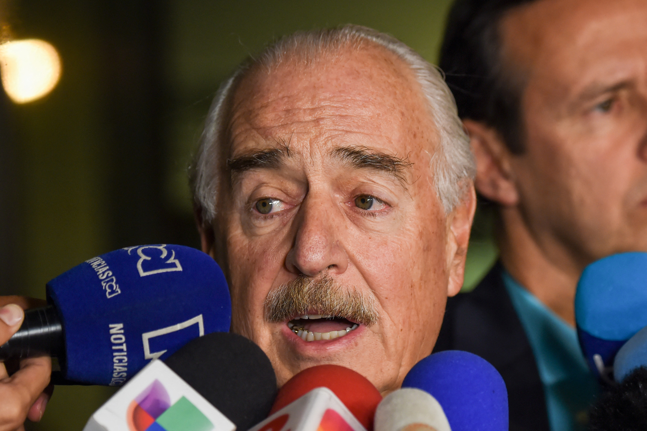 (FILES) Former Colombian president (1998-2002) Andres Pastrana (L) speaks to the press next to former Bolivian president (2001-2002) Jorge Quiroga, upon their arrival at El Dorado airport, in Bogota, Colombia, on March 7, 2018, after being deported from Cuba.