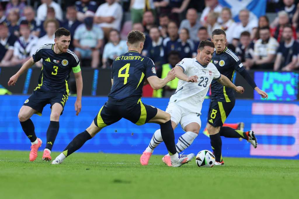 Cologne (Germany), 19/06/2024.- Xherdan Shaqiri (2-R) of Switzerland in action against Scott McTominay of Scotland during the UEFA EURO 2024 group A soccer match between Scotland and Switzerland, in Cologne, Germany, 19 June 2024. (Alemania, Suiza, Colonia) EFE/EPA/GEORGI LICOVSKI