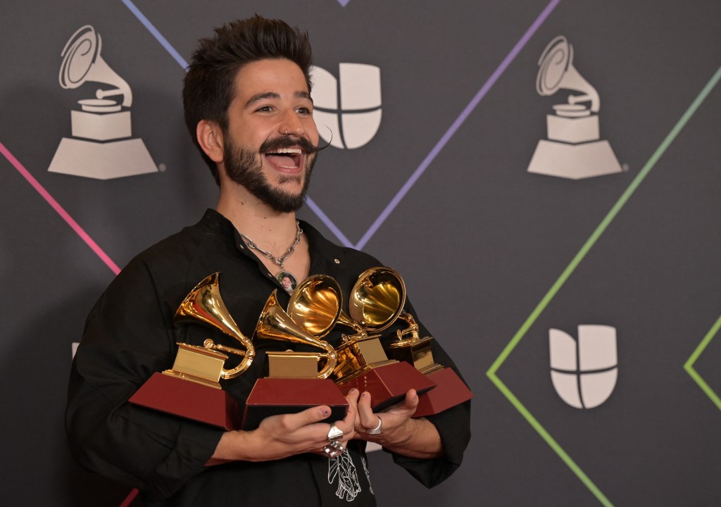 Colombian singer Camilo poses with his awards in the press room during the 22nd Annual Latin Grammy awards at the MGM Grand Arena in Las Vegas, Nevada, November 18, 2021. (Photo by Bridget BENNETT / AFP)