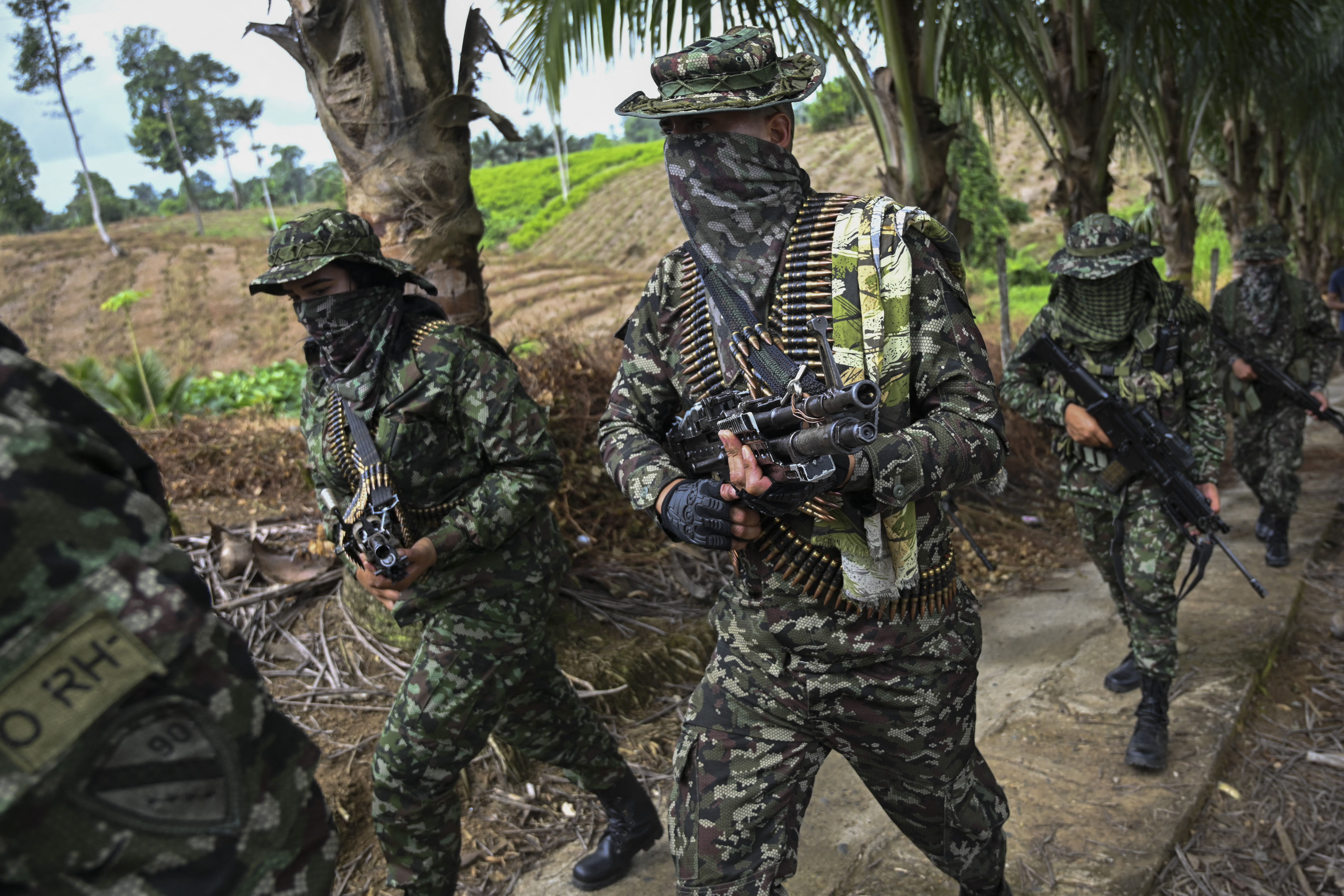 Members of the FARC dissident group Segunda Marquetalia marches on a farm in Llorente, a rural area of the port city of Tumaco, Nariño department, Colombia, on August 31, 2024.