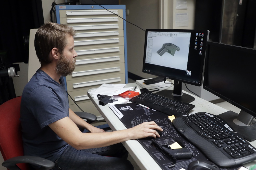 Ben Chalker shows the CAD software of a 3D-printable gun called the Liberator, Wednesday, Aug. 1, 2018, in Austin, Texas. A federal judge in Seattle issued a temporary restraining order Tuesday to stop the release of blueprints to make untraceable and undetectable 3D-printed plastic guns. (AP Photo/Eric Gay)